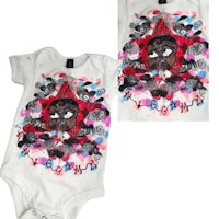 a white baby bodysuit with a black face on it